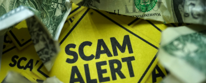 Scam alert sign surrounded by dollar bills, highlighting the importance of avoiding fraudulent schemes.