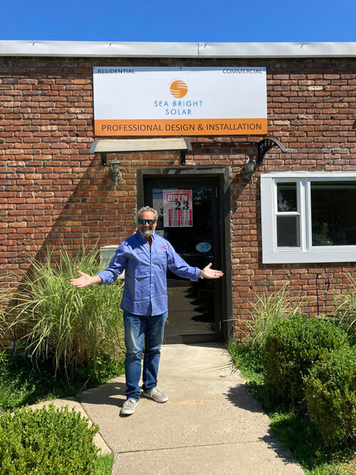 Michael Trapani in Front of Sea Bright Solar Office Building for Professional Design and Installation