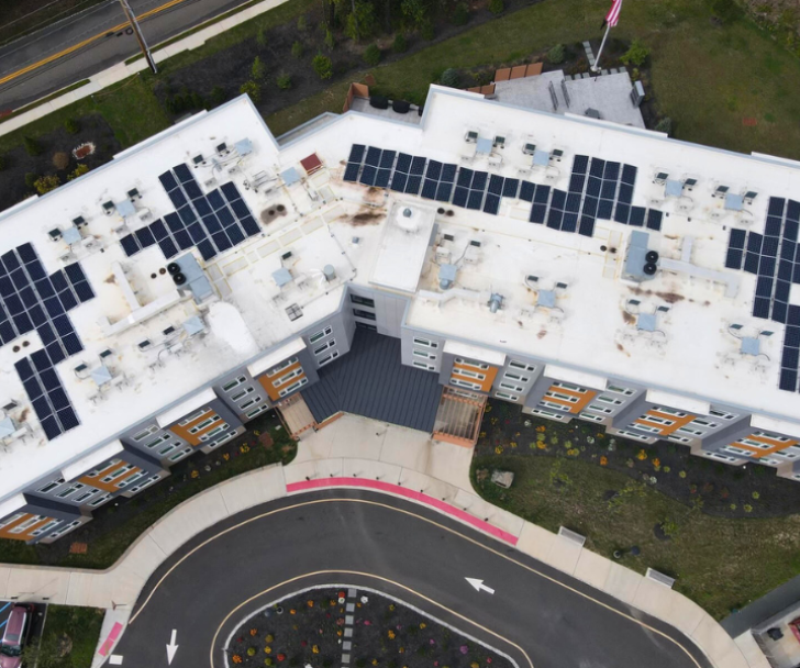 Industrial an aerial view of a building with solar panels on the roof