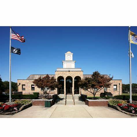 barnegat lighthouse on Long Beach Island New Jersey with coastal shoreline and blue sky, historic lighthouse landmark and seaside destination
