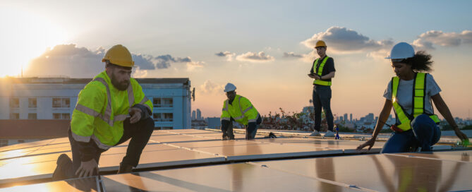 Solar technicians inspecting rooftop solar panels at sunset, ensuring proper installation, maintenance, and long-term system performance.