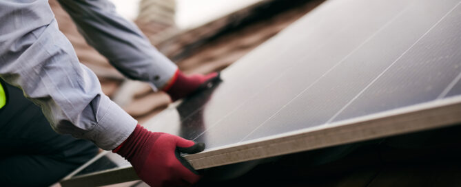Solar removal and reinstallation technician removing rooftop solar panels before a roof replacement project
